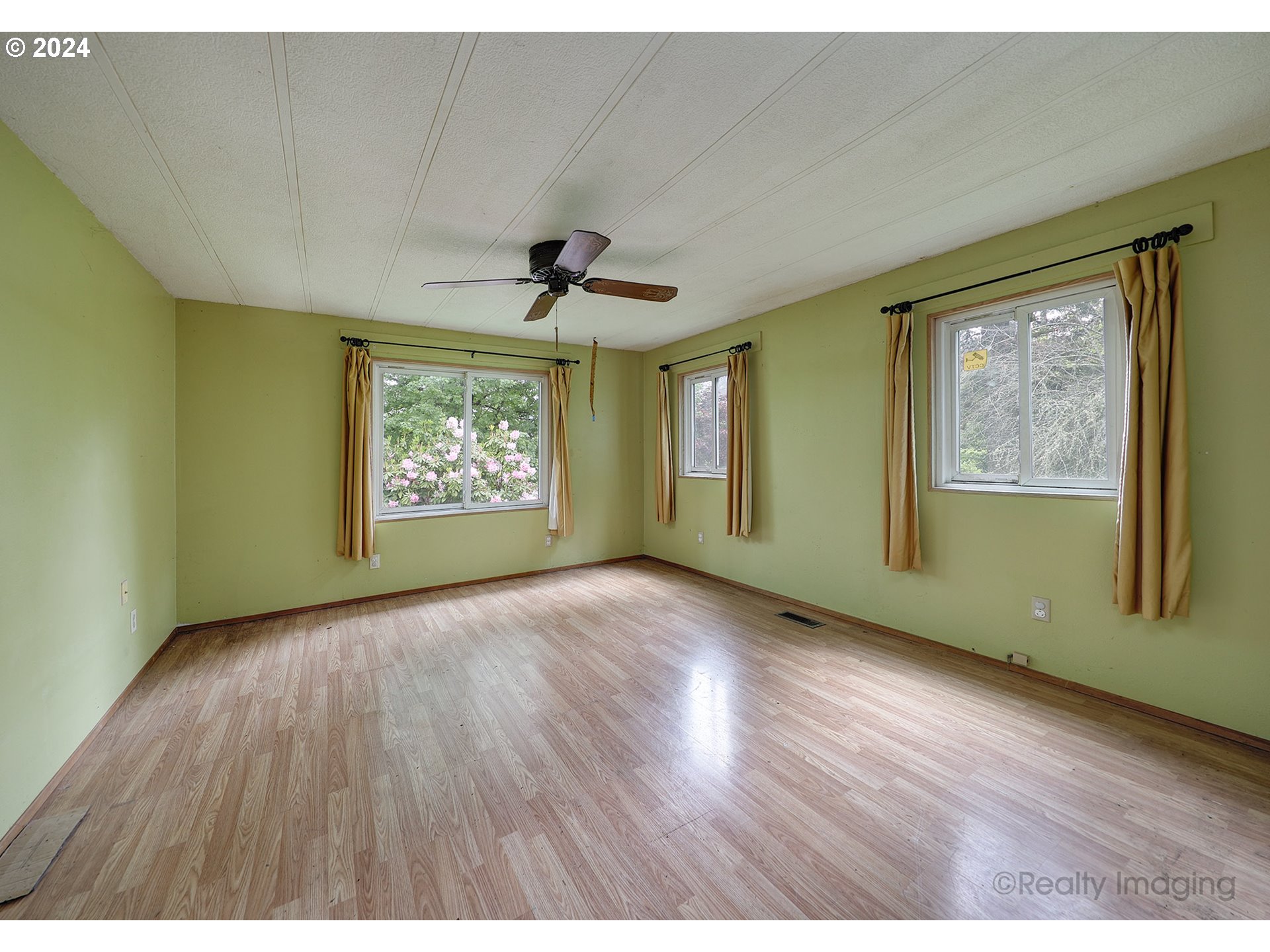 48886 Southeast Coalman Road Sandy, OR 97055 - Photo 6 of 16 a view of an empty room with a window and wooden floor