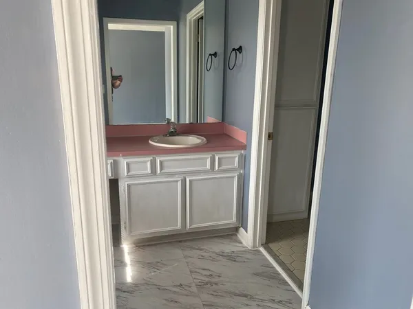 a view of a bathroom with a sink and a mirror