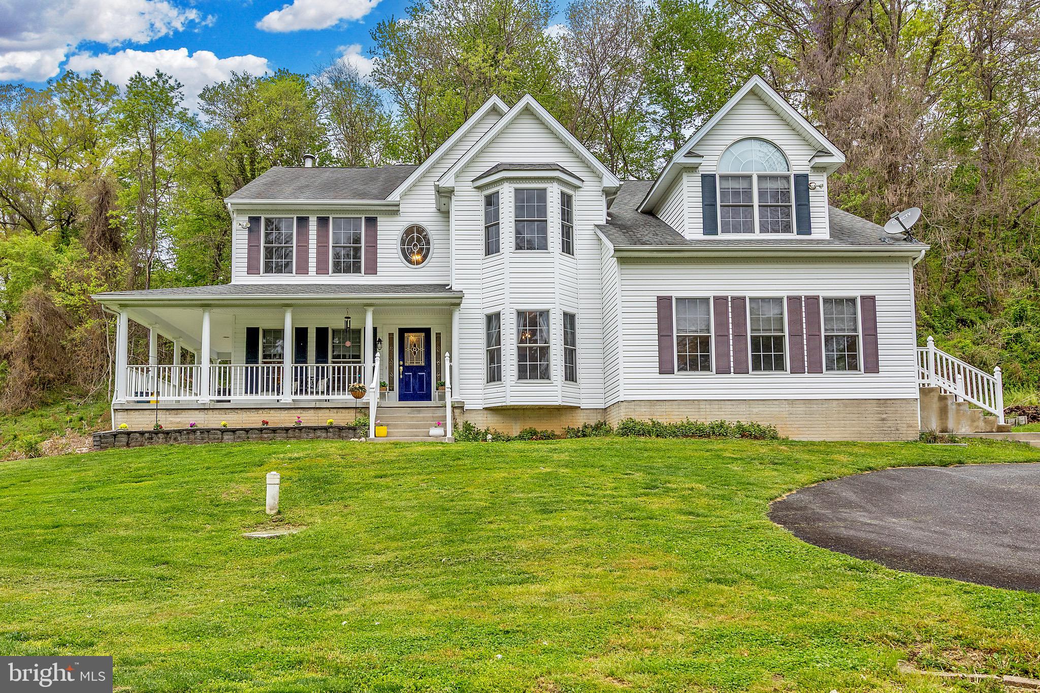 3610 Ady Road Street, MD 21154 - Photo 60 of 61 a house with a big yard and potted plants in front of house