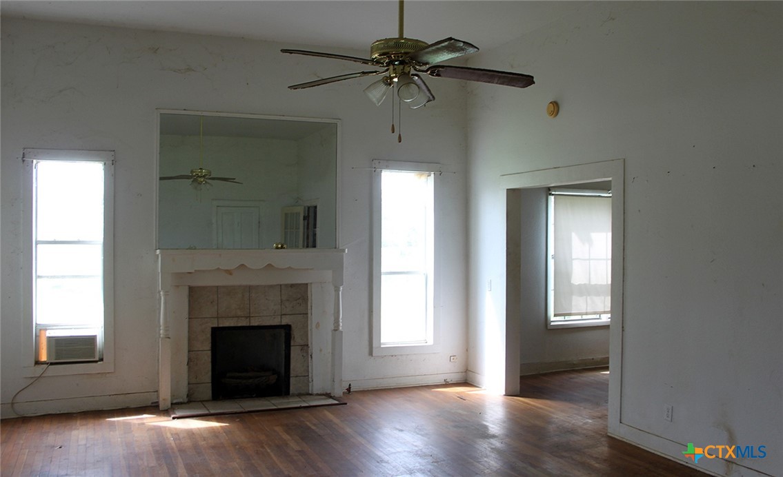 108 Sorrell Street Red Rock, TX 78662 - Photo 32 of 36 a view of an empty room with a fireplace and a window