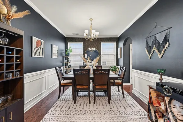 a view of a dining room with furniture and chandelier