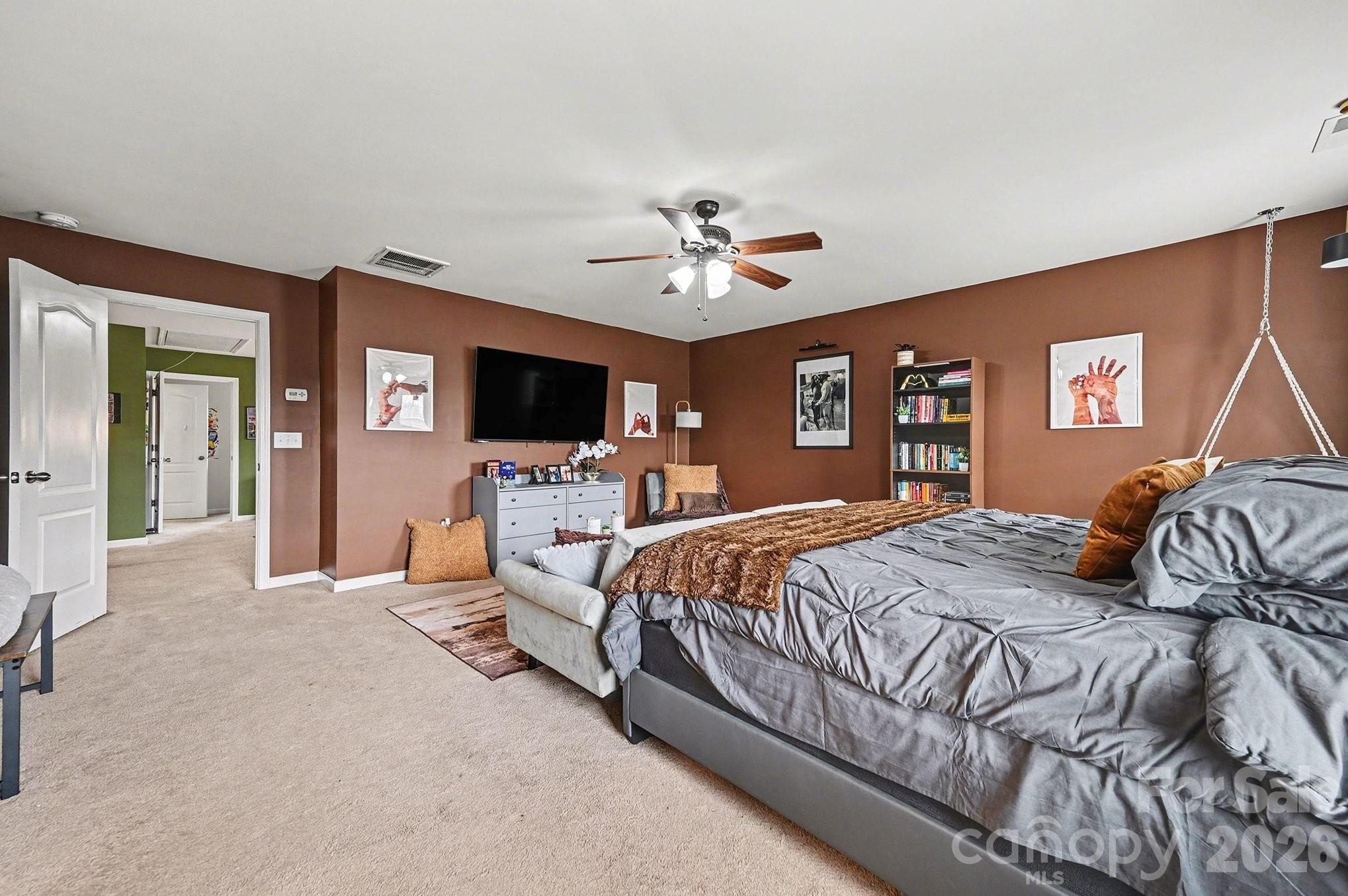 12614 Chantrey Way Huntersville, NC 28078 - Photo 14 of 31 a bedroom with a large bed and flat screen tv