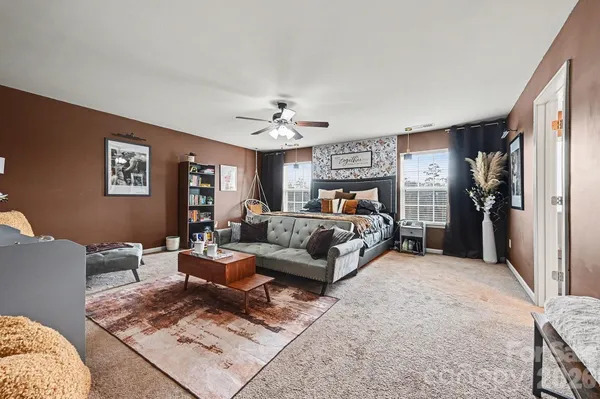 a bedroom with furniture and a chandelier