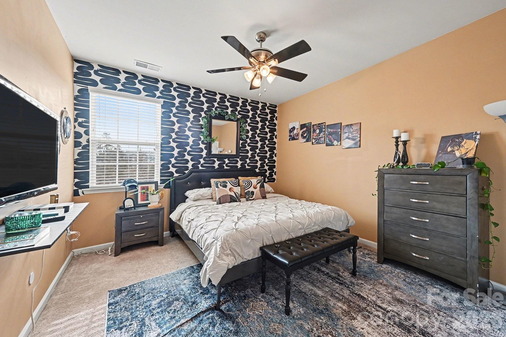 12614 Chantrey Way Huntersville, NC 28078 - Photo 17 of 31 a bedroom with a bed and a flat screen tv