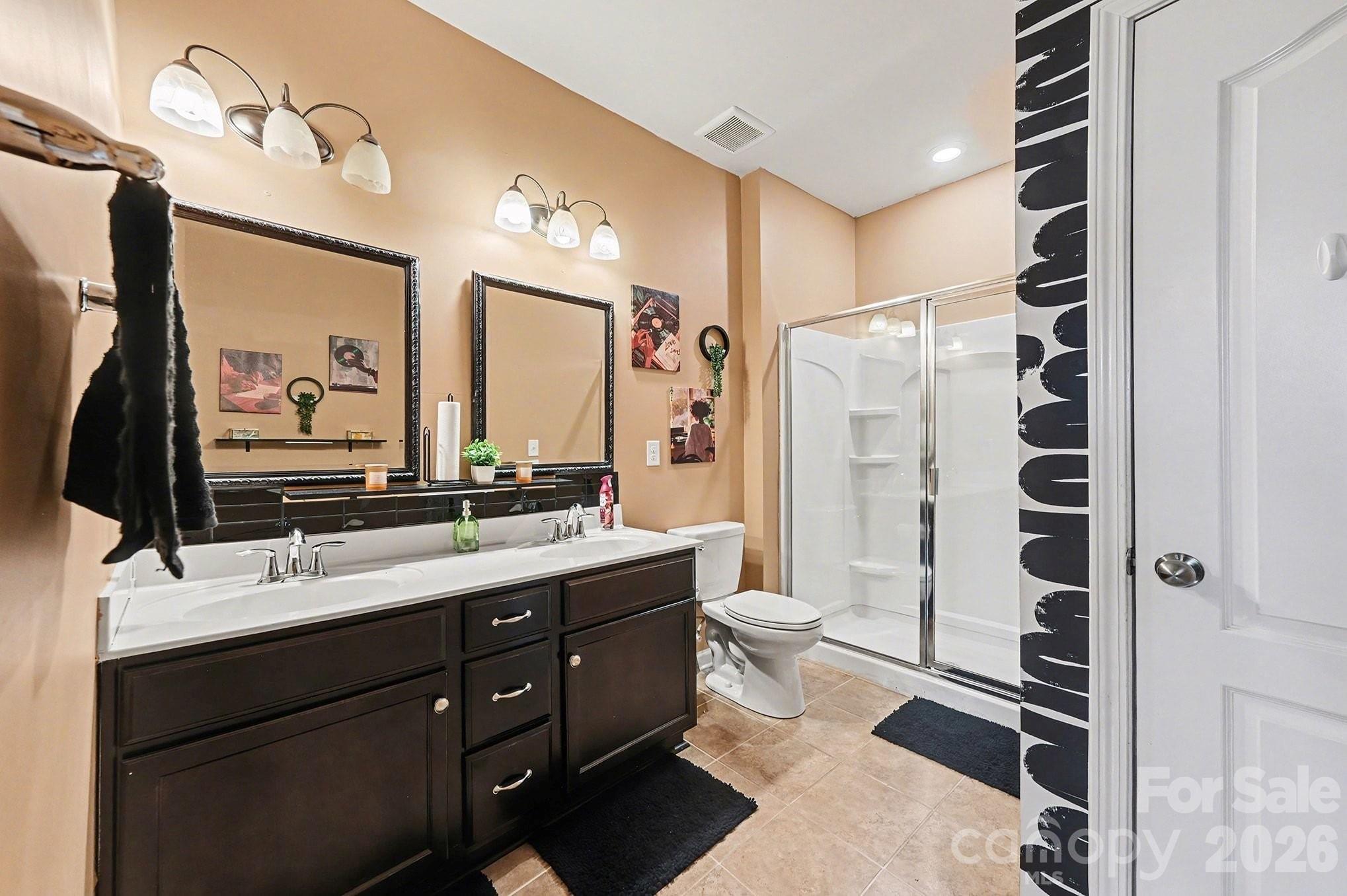 12614 Chantrey Way Huntersville, NC 28078 - Photo 18 of 31 a bathroom with a double vanity sink toilet mirror and shower