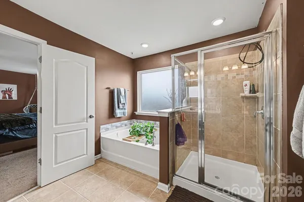 a bathroom with a glass shower door and a sink