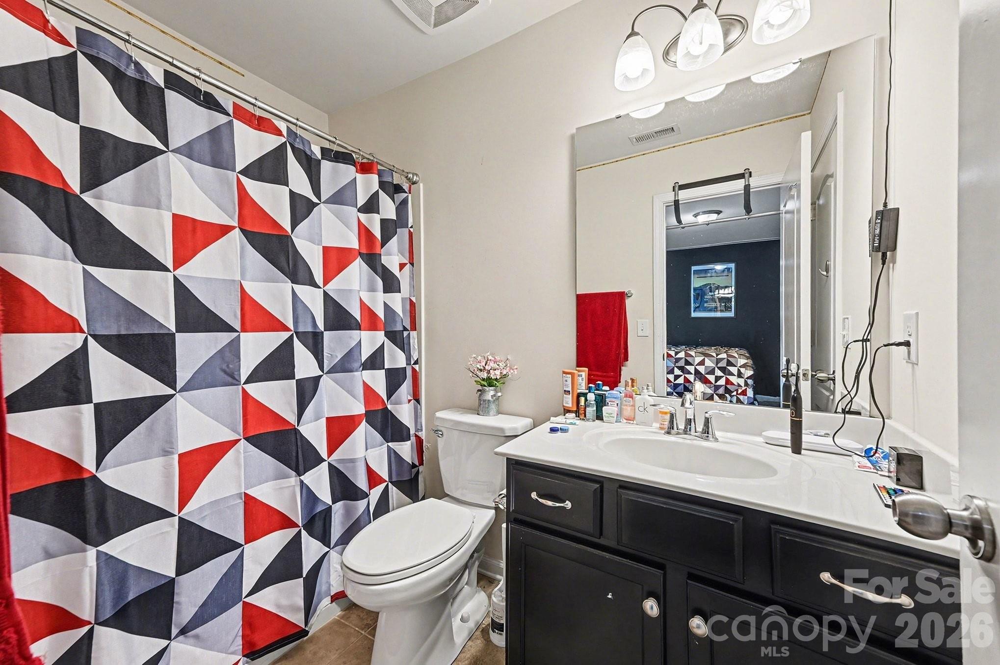 12614 Chantrey Way Huntersville, NC 28078 - Photo 21 of 31 a bathroom with a sink a toilet and shower curtain