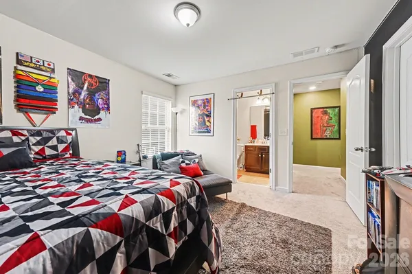 a bedroom with a bed and a chandelier