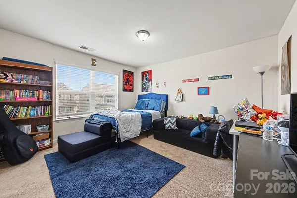a bedroom with furniture and a book shelf