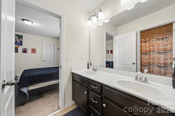 a bathroom with a sink double vanity and a mirror