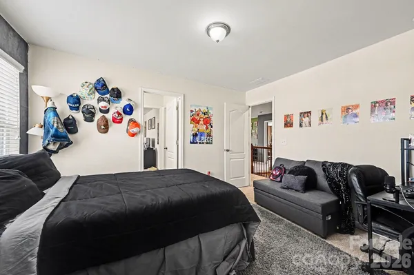 a bedroom with a bed and a couch