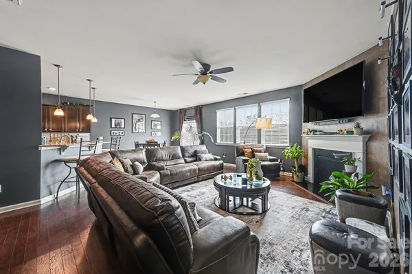 a living room with fireplace furniture and a flat screen tv