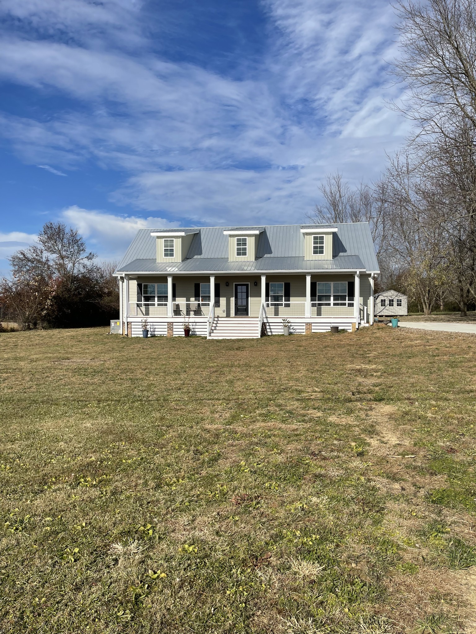 136 Dunn Fall River Road Leoma, TN 38468 - Photo 1 of 25 a front view of a building with a garden