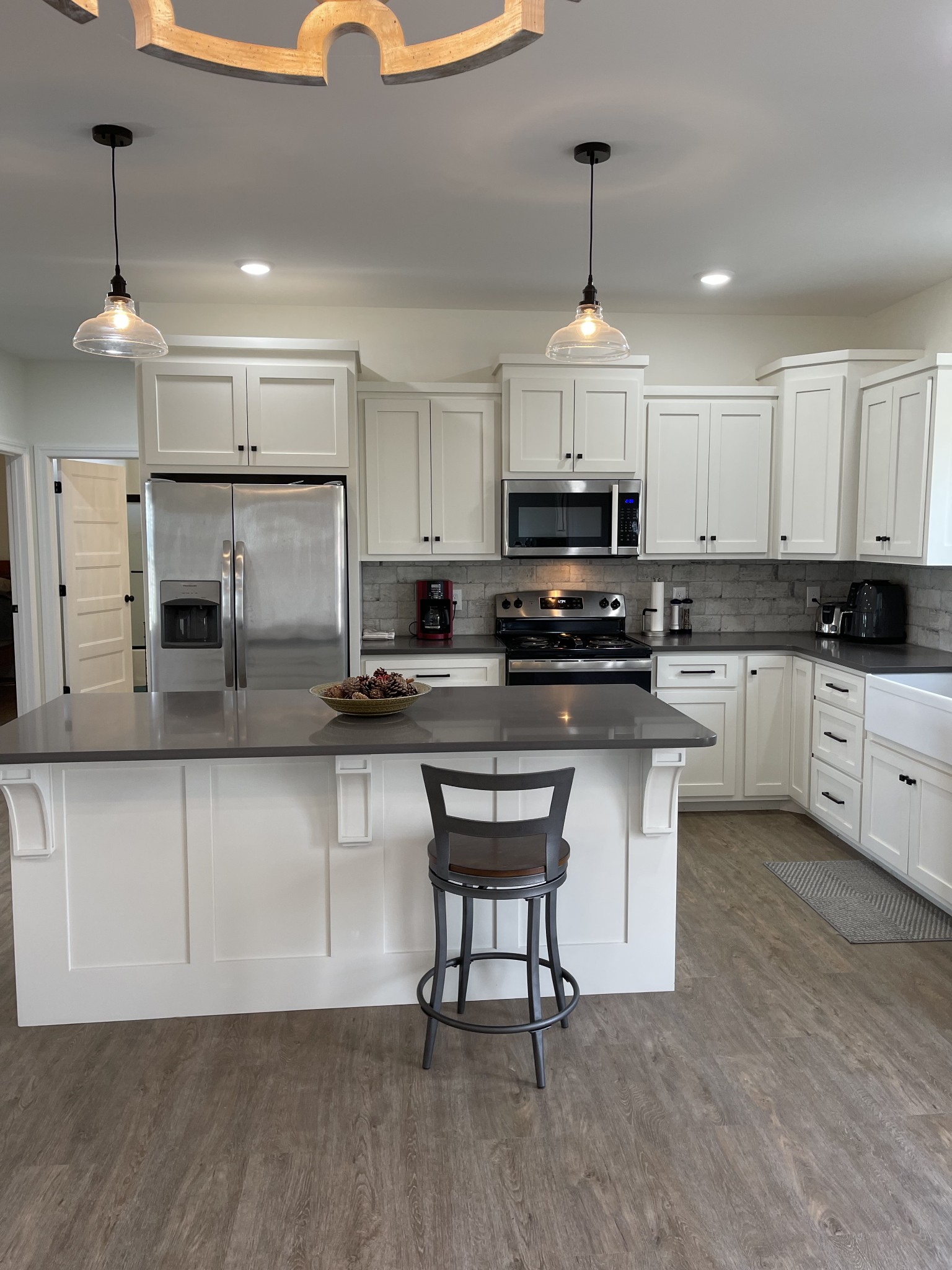 136 Dunn Fall River Road Leoma, TN 38468 - Photo 10 of 25 a kitchen with stainless steel appliances granite countertop a stove a sink a microwave a refrigerator and white cabinets