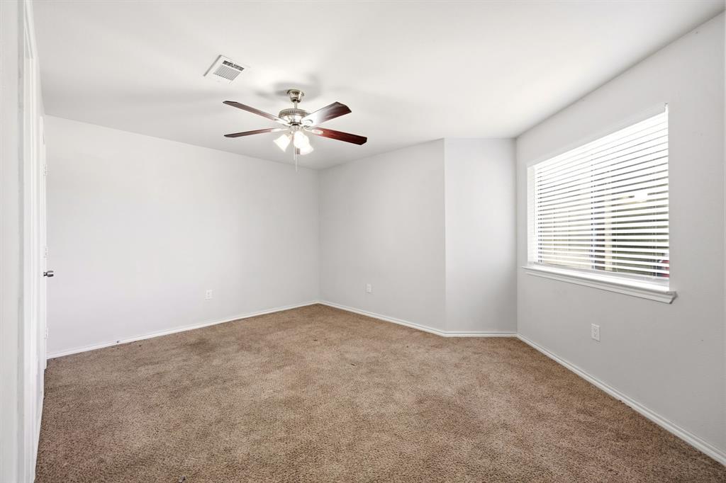 9837 Walnut Street, Unit S203 Dallas, TX 75243 - Photo 13 of 26 This room features light-colored walls, brown carpet, and a ceiling fan with a light fixture