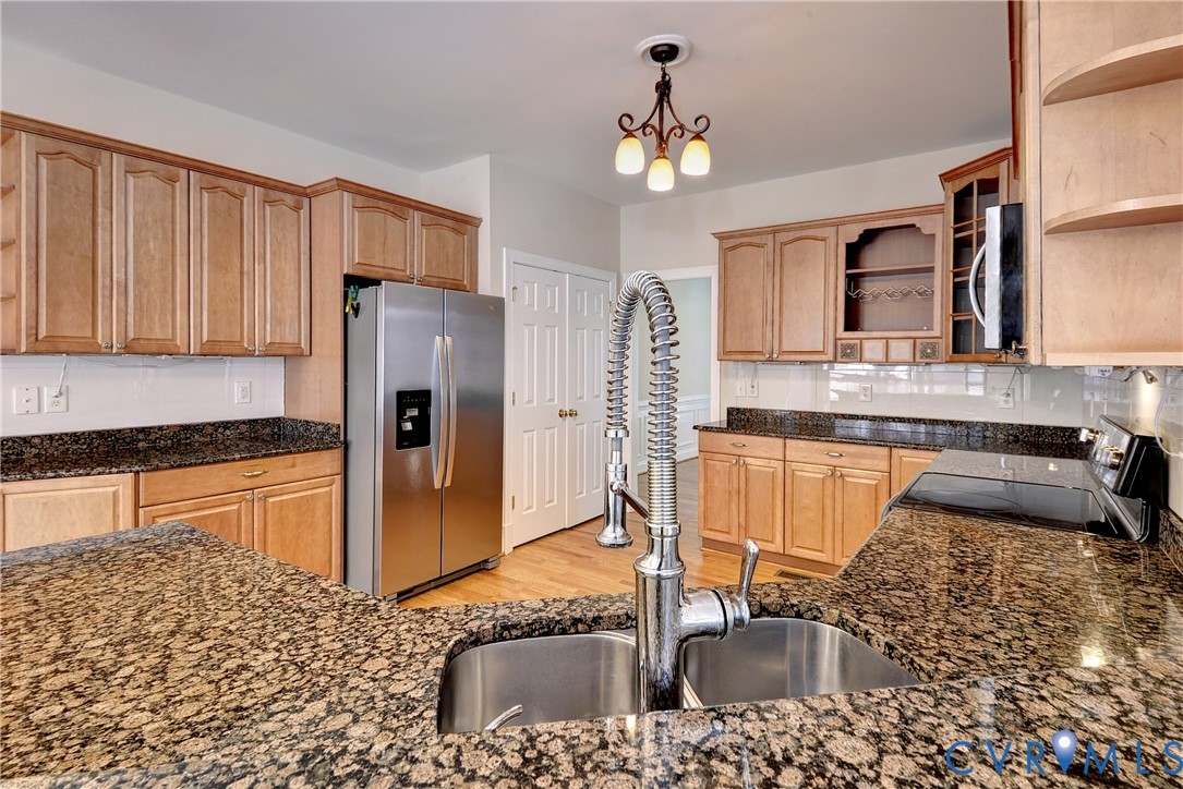 11385 Winding River Road Providence Forge, VA 23140 - Photo 7 of 43 a kitchen with stainless steel appliances granite countertop a sink refrigerator and cabinets