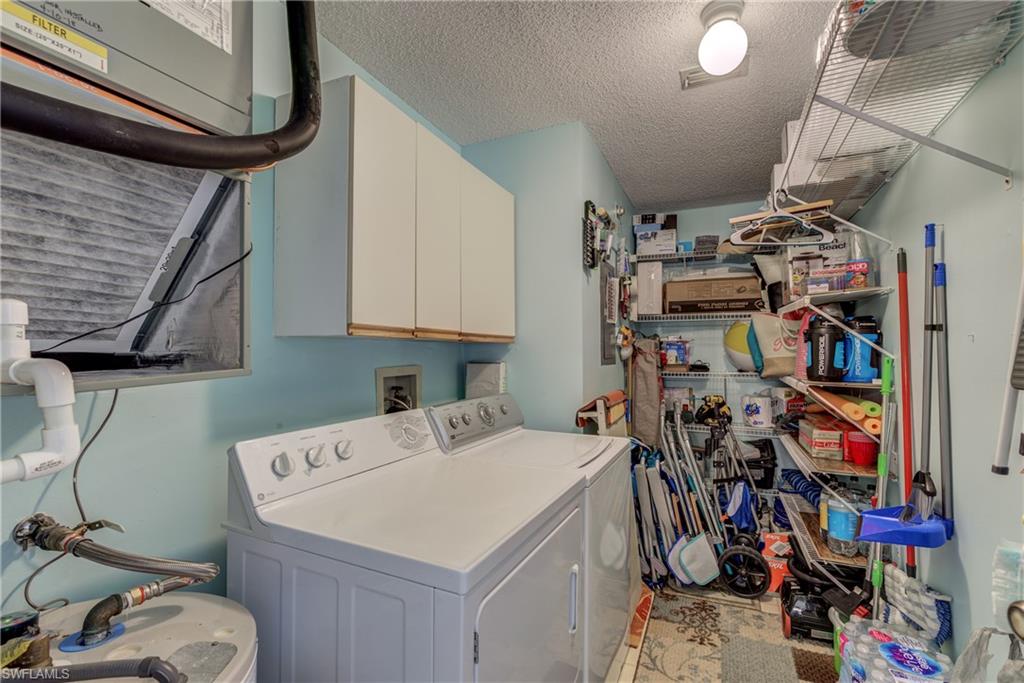 760 Augusta Boulevard, Unit D204 Naples, FL 34113 - Photo 12 of 32 a utility room with dryer washer and other items