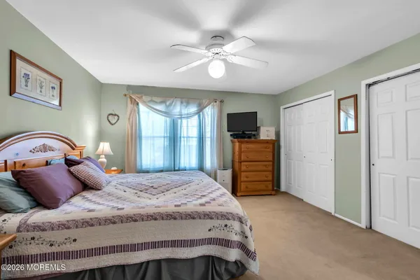 a bedroom with a bed and a television