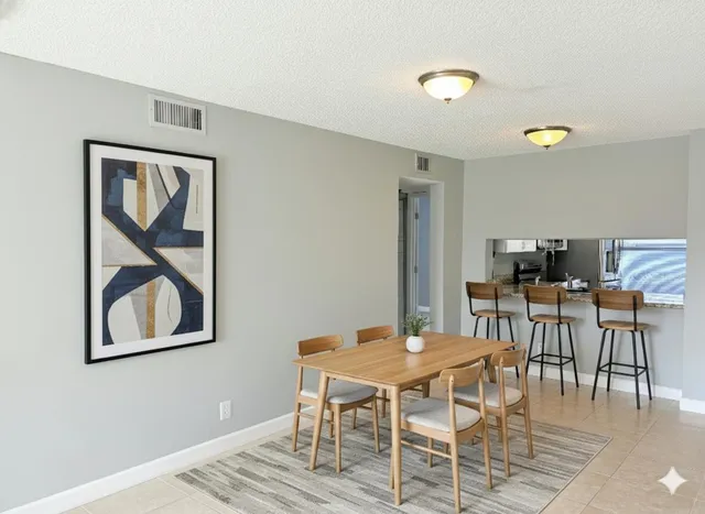 a kitchen with stainless steel appliances granite countertop a refrigerator a sink a stove a microwave and wooden cabinets