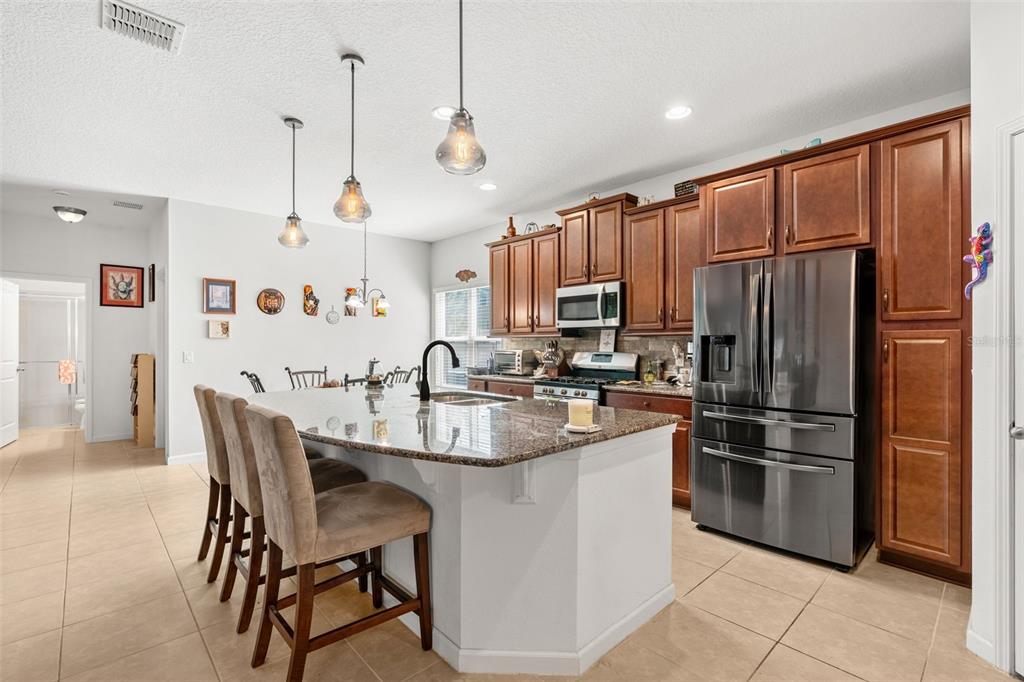 2085 Lula Road Minneola, FL 34715 - Photo 17 of 39 a kitchen with kitchen island a counter top space appliances and cabinets