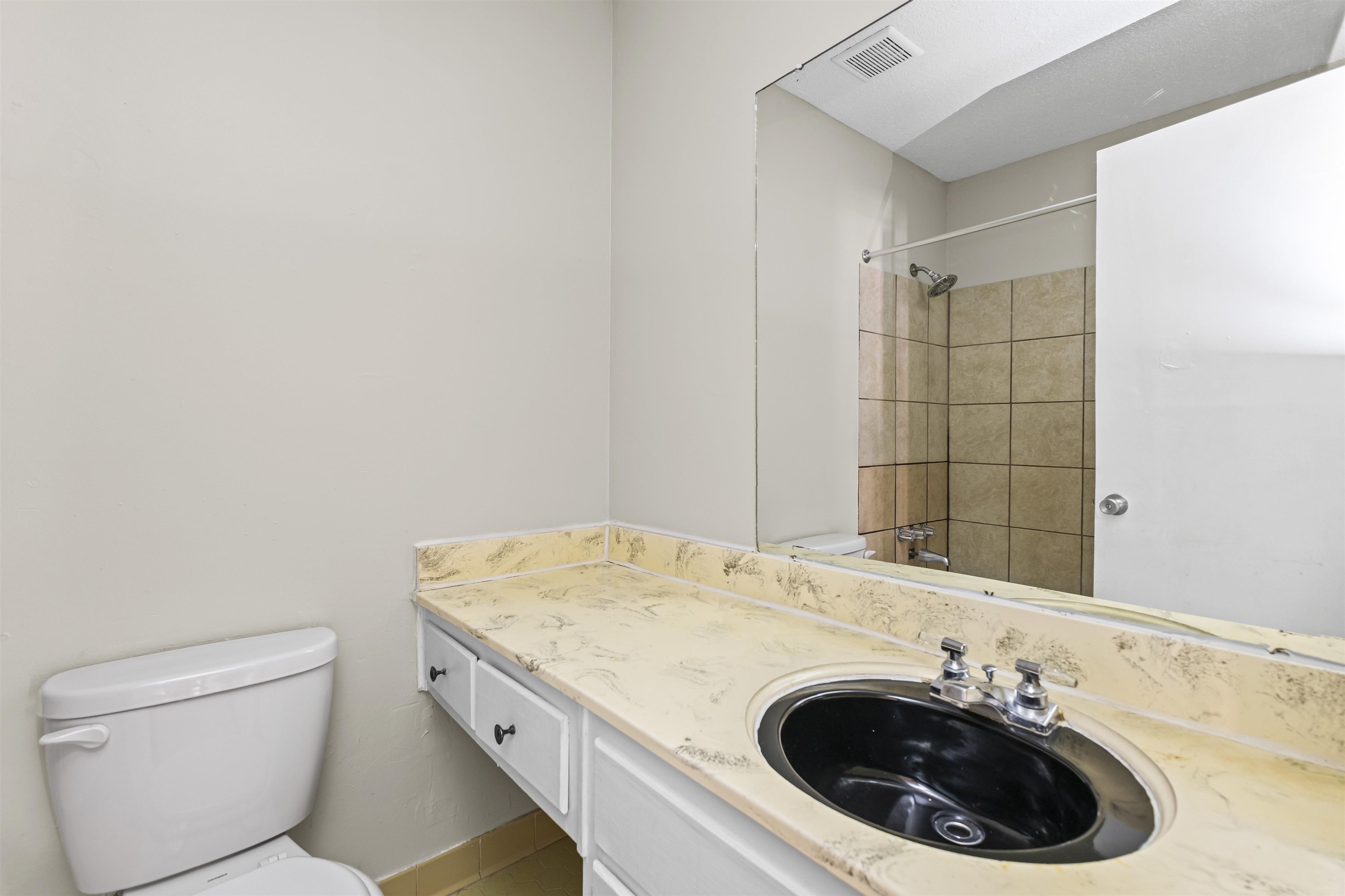4982 Holly Ridge Drive Memphis, TN 38118 - Photo 11 of 26 a bathroom with a granite countertop sink a toilet and a mirror
