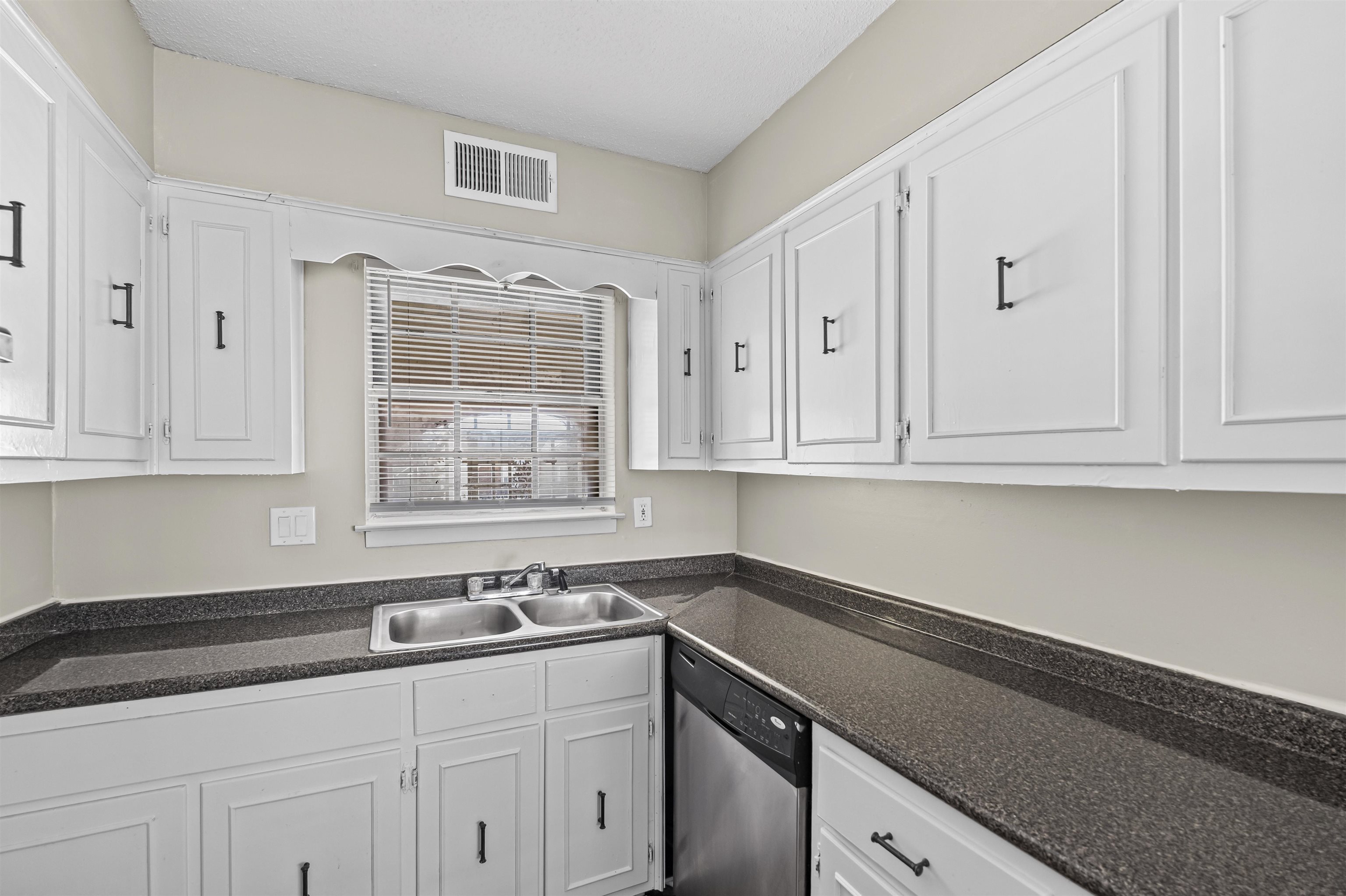 4982 Holly Ridge Drive Memphis, TN 38118 - Photo 16 of 26 a kitchen with granite countertop white cabinets and a sink
