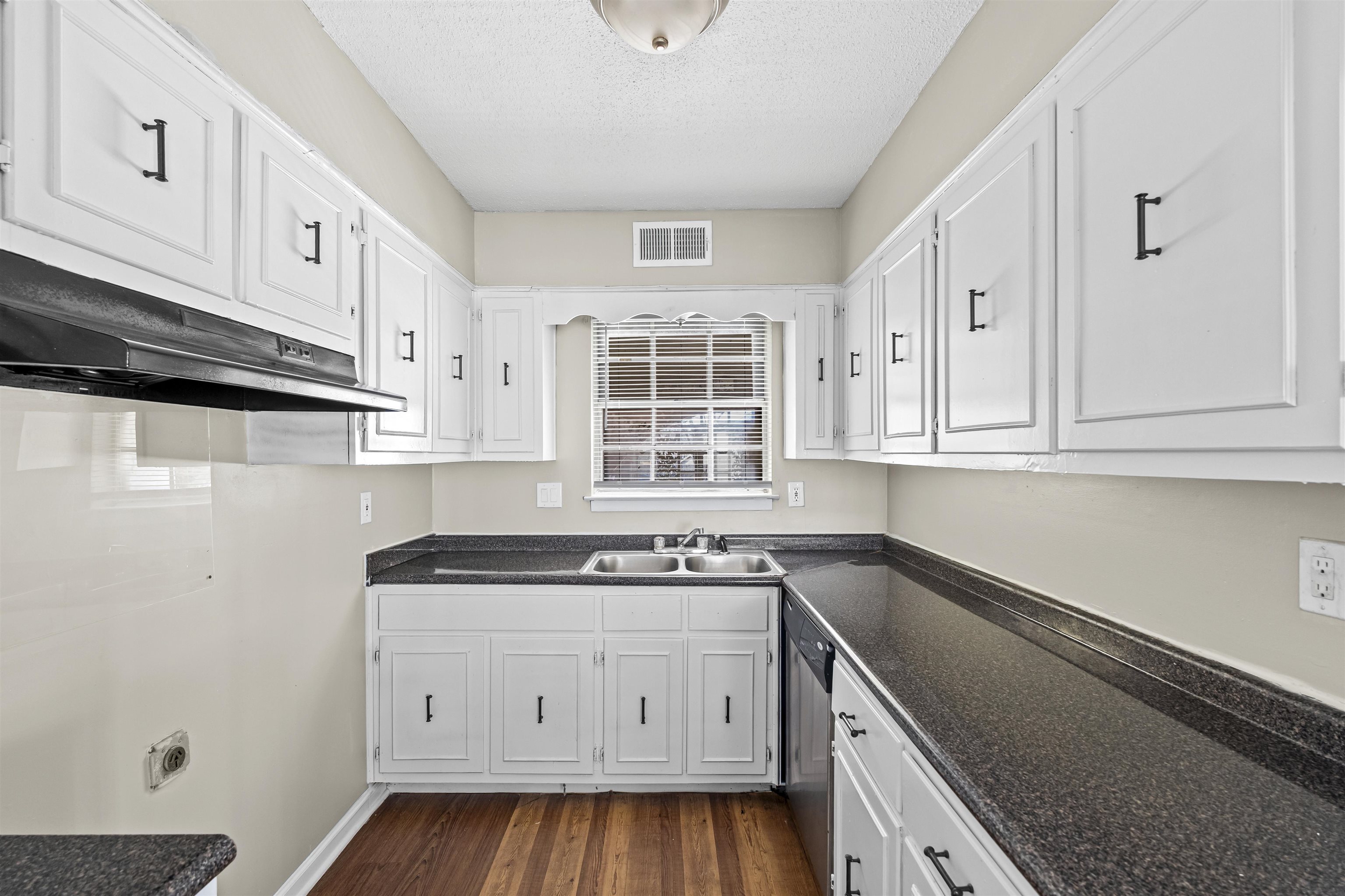 4982 Holly Ridge Drive Memphis, TN 38118 - Photo 17 of 26 a kitchen with a sink stove and cabinets
