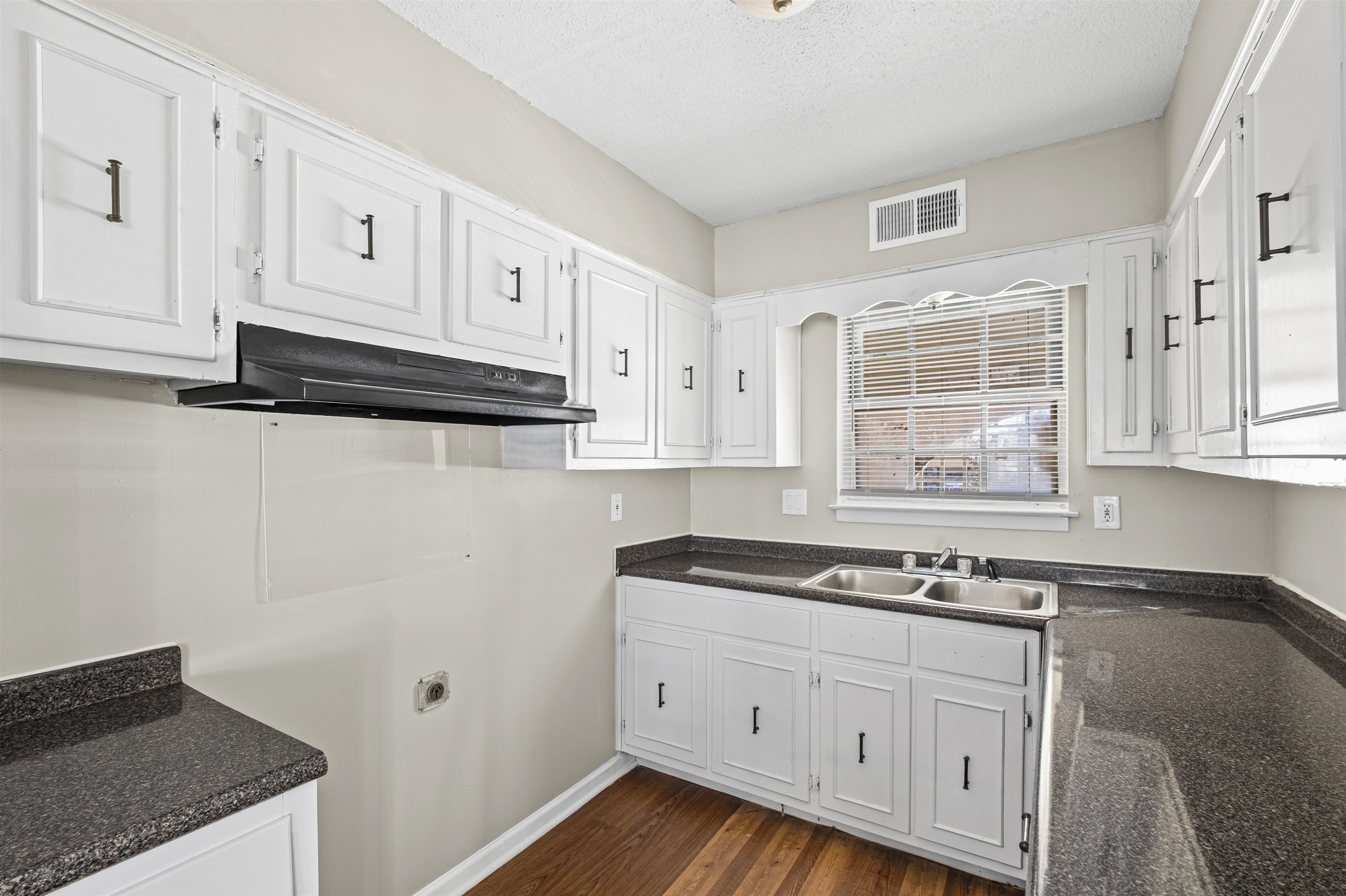 4982 Holly Ridge Drive Memphis, TN 38118 - Photo 18 of 26 a kitchen with granite countertop white cabinets and white appliances