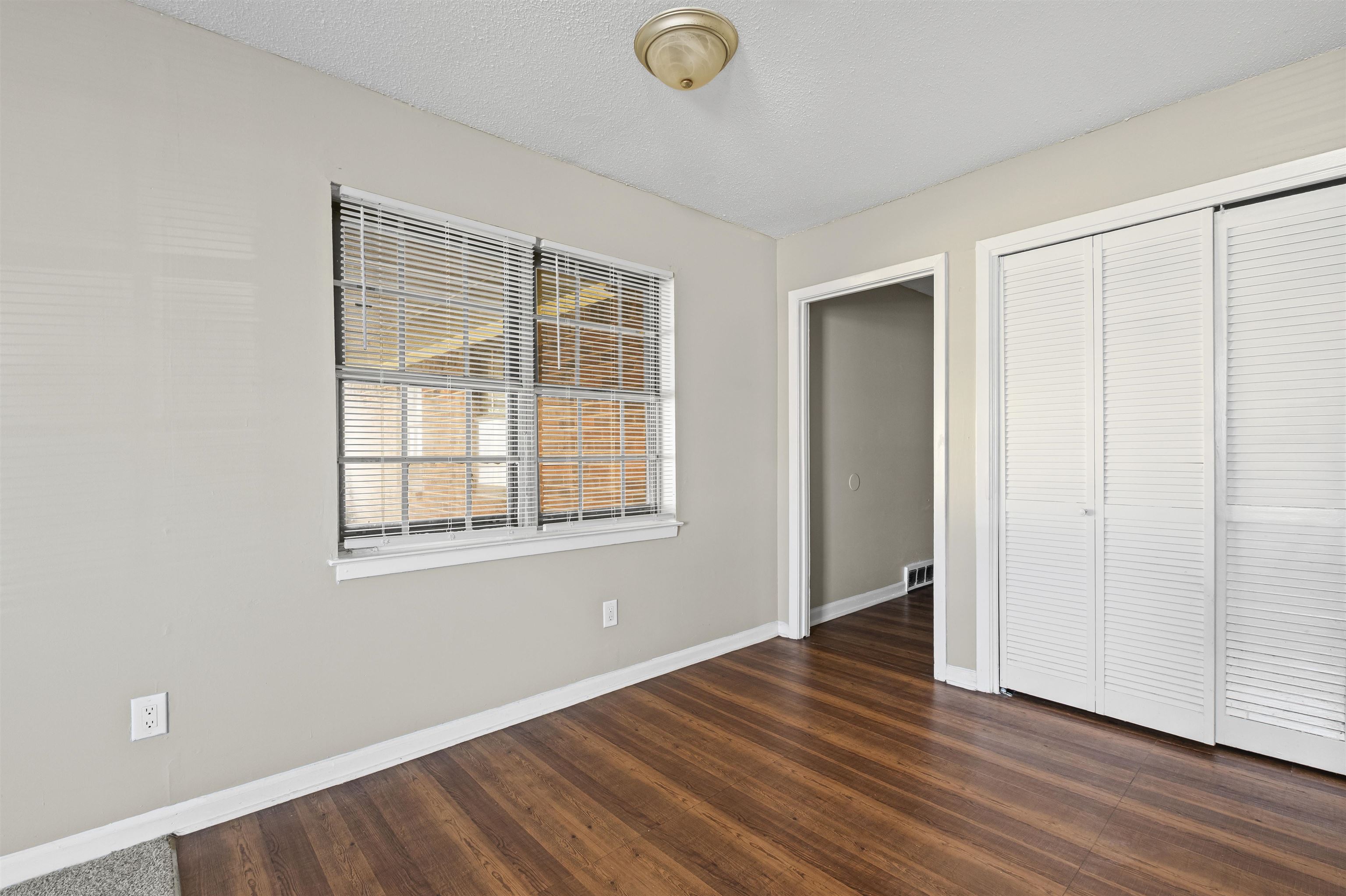 4982 Holly Ridge Drive Memphis, TN 38118 - Photo 20 of 26 an empty room with wooden floor and windows