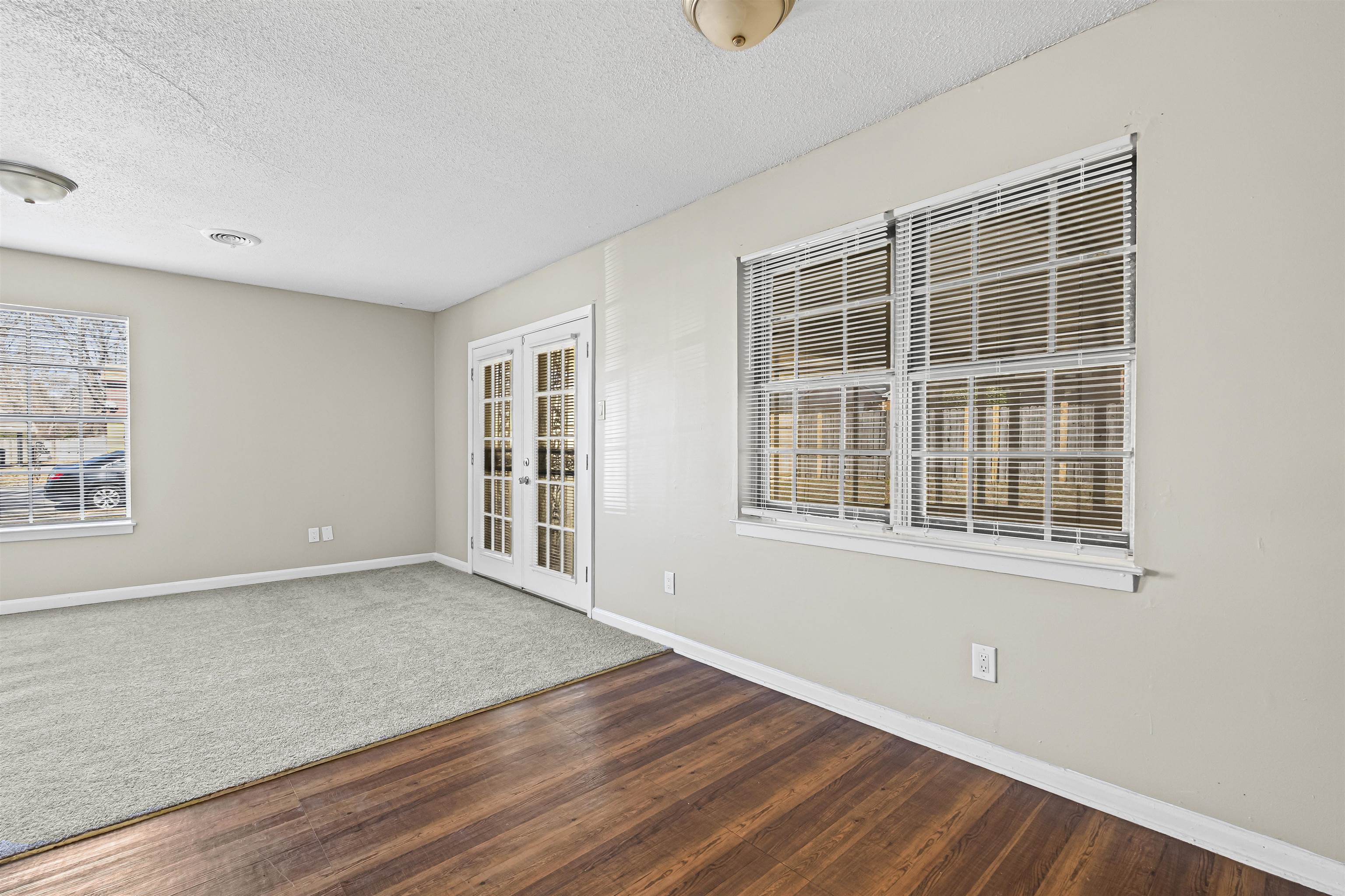 4982 Holly Ridge Drive Memphis, TN 38118 - Photo 8 of 26 an empty room with wooden floor and windows