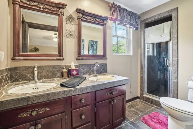 a view of a lake with couches chairs and wooden floor