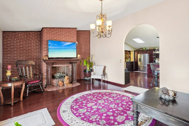a front view of a house with a garden and trees