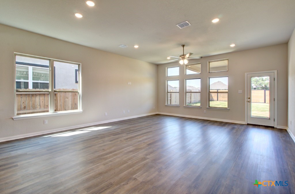 2129 Shepards Street Seguin, TX 78155 - Photo 11 of 29 a view of an empty room with wooden floor and a window