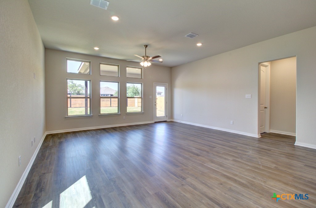 2129 Shepards Street Seguin, TX 78155 - Photo 13 of 29 a view of an empty room with wooden floor and a window
