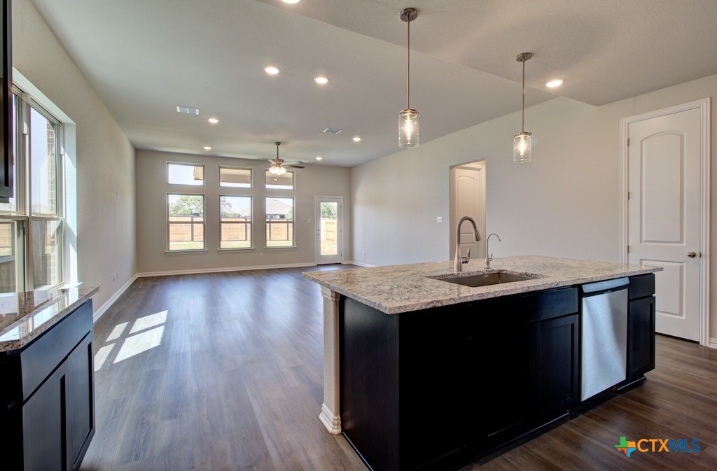 2129 Shepards Street Seguin, TX 78155 - Photo 14 of 29 a kitchen with center island and a wooden floor
