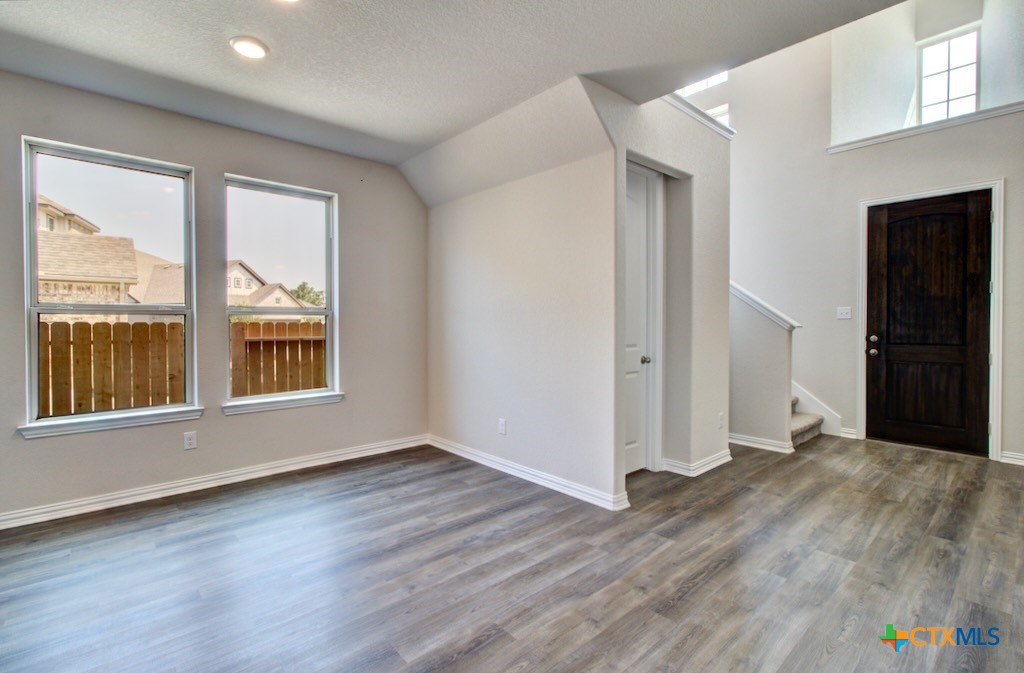 2129 Shepards Street Seguin, TX 78155 - Photo 2 of 29 a view of an empty room with wooden floor and a window