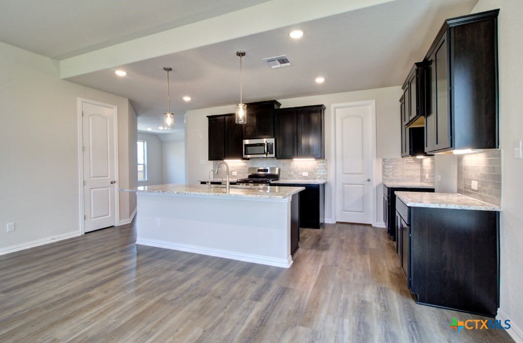 2129 Shepards Street Seguin, TX 78155 - Photo 9 of 29 a large kitchen with stainless steel appliances granite countertop a stove a sink and a refrigerator