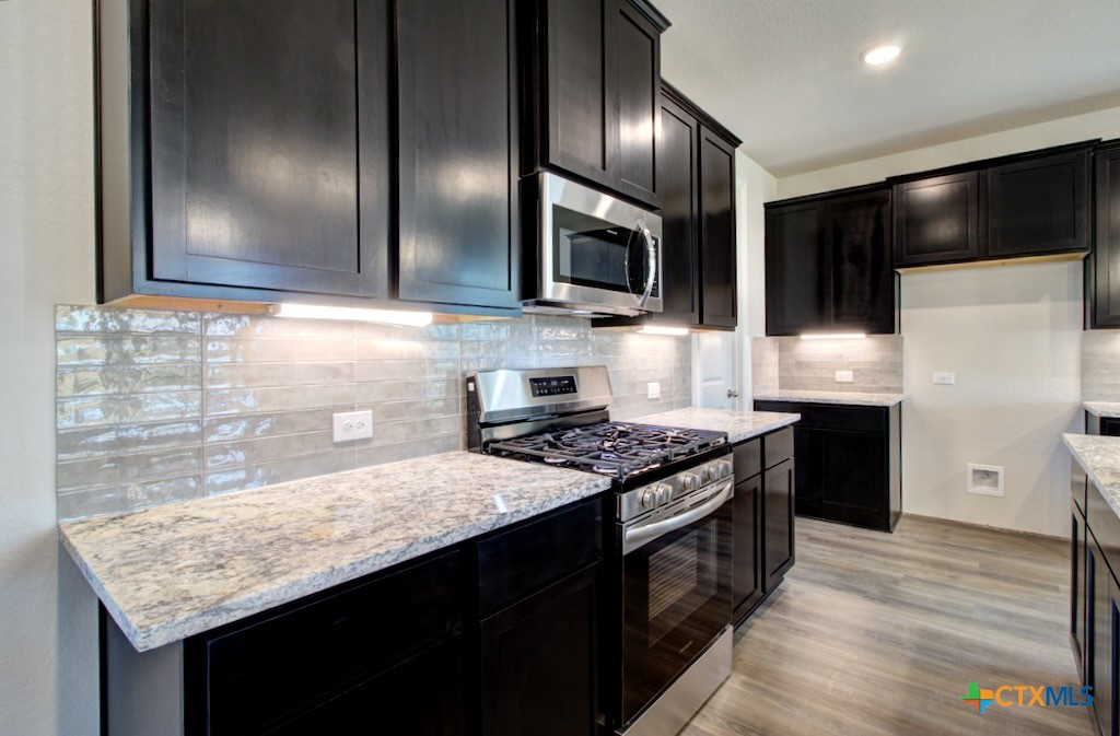 2129 Shepards Street Seguin, TX 78155 - Photo 10 of 29 a kitchen with stainless steel appliances granite countertop a sink stove and refrigerator