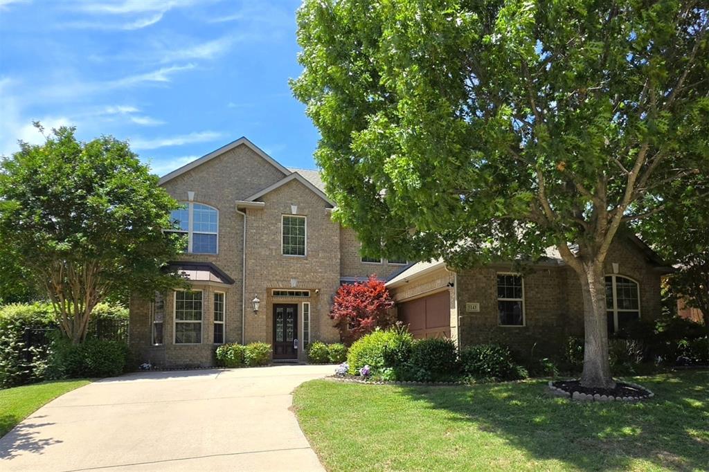 5143 Stream Crest Way Fairview, TX 75069 - Photo 1 of 35 Two-story brick exterior featuring a multi-pane front door, bay window, arched window details, and mature landscaping