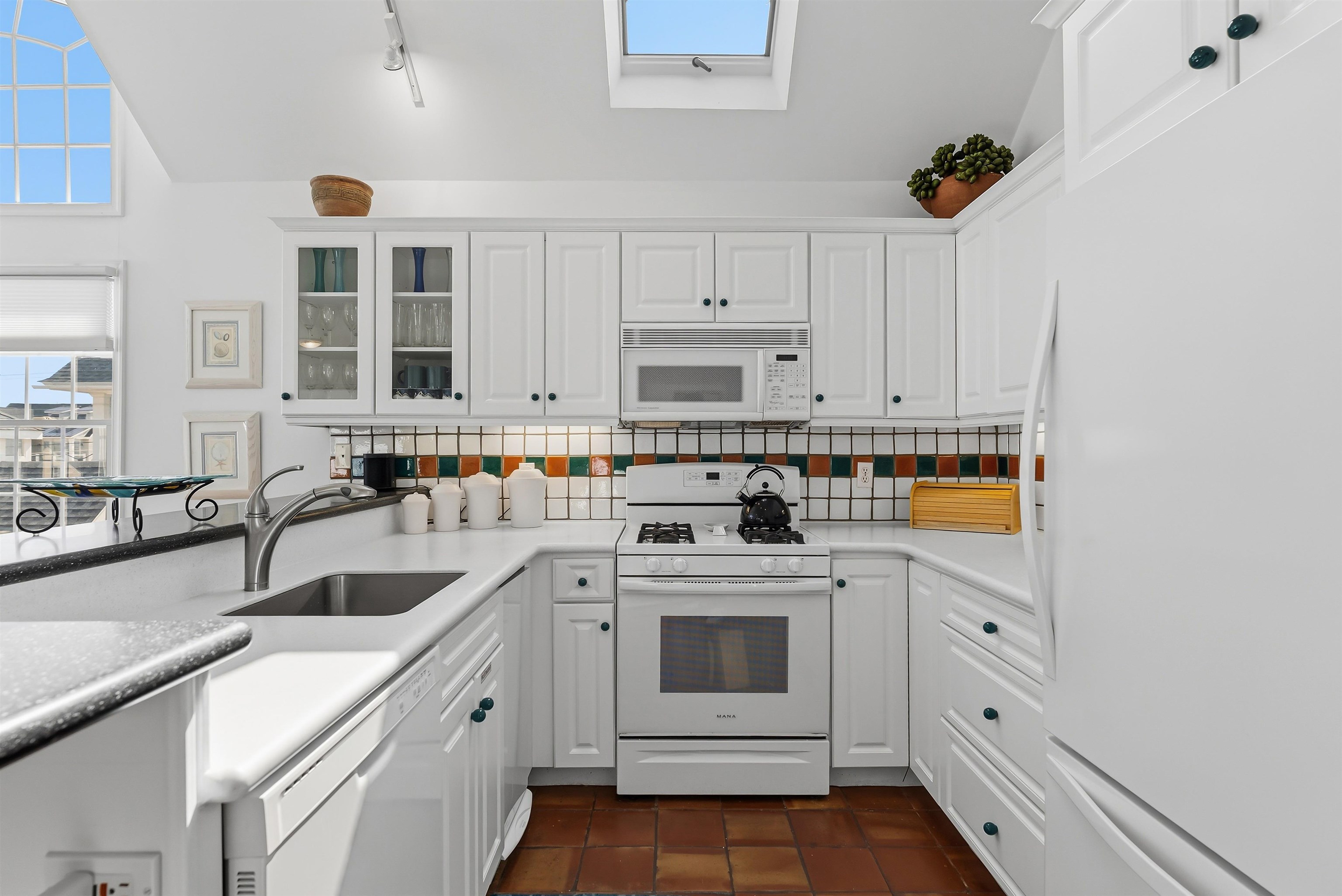 125 98th Street Stone Harbor, NJ 08247 - Photo 12 of 42 a kitchen with cabinets appliances and a sink