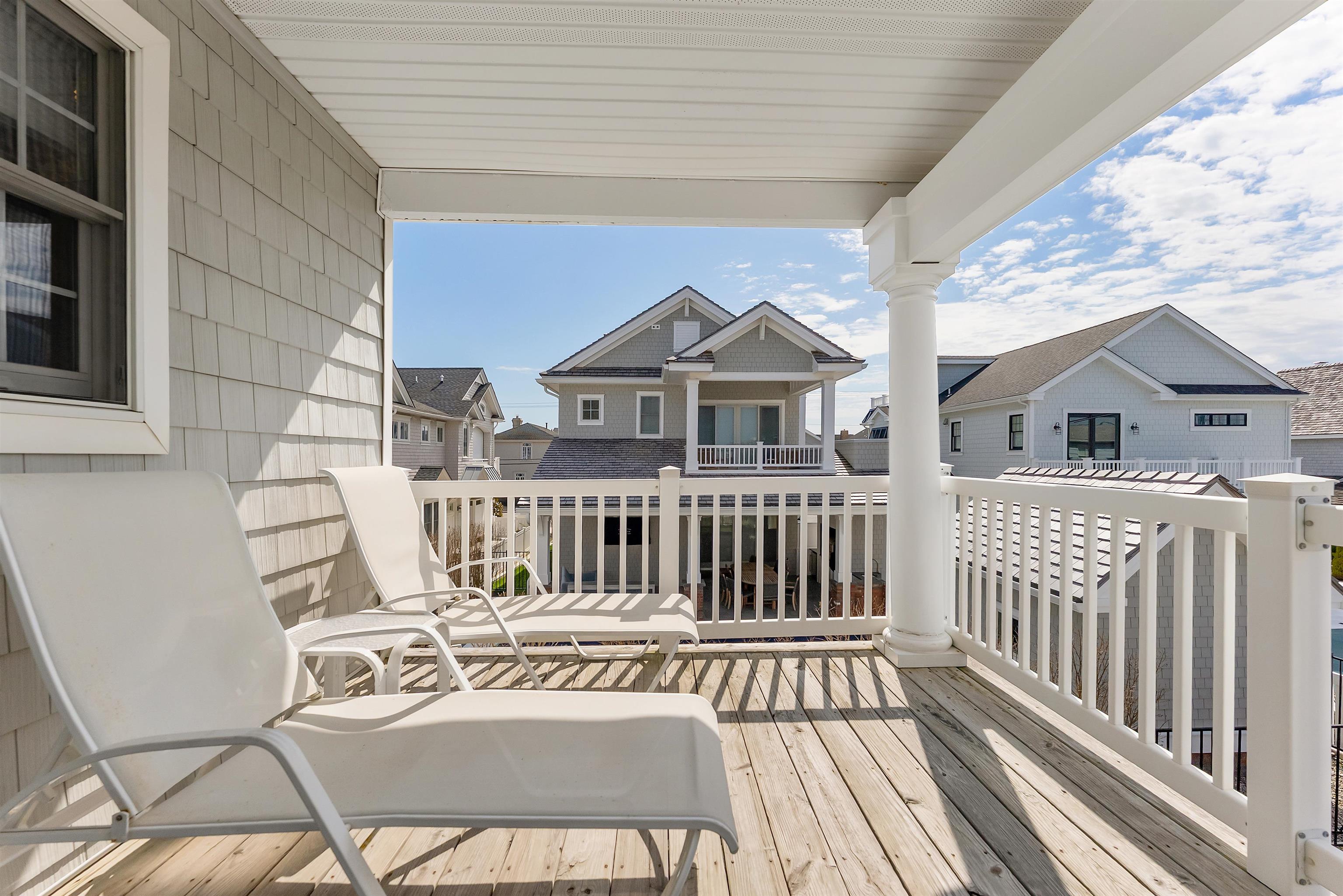 125 98th Street Stone Harbor, NJ 08247 - Photo 21 of 42 a view of a chair and tables front of the house