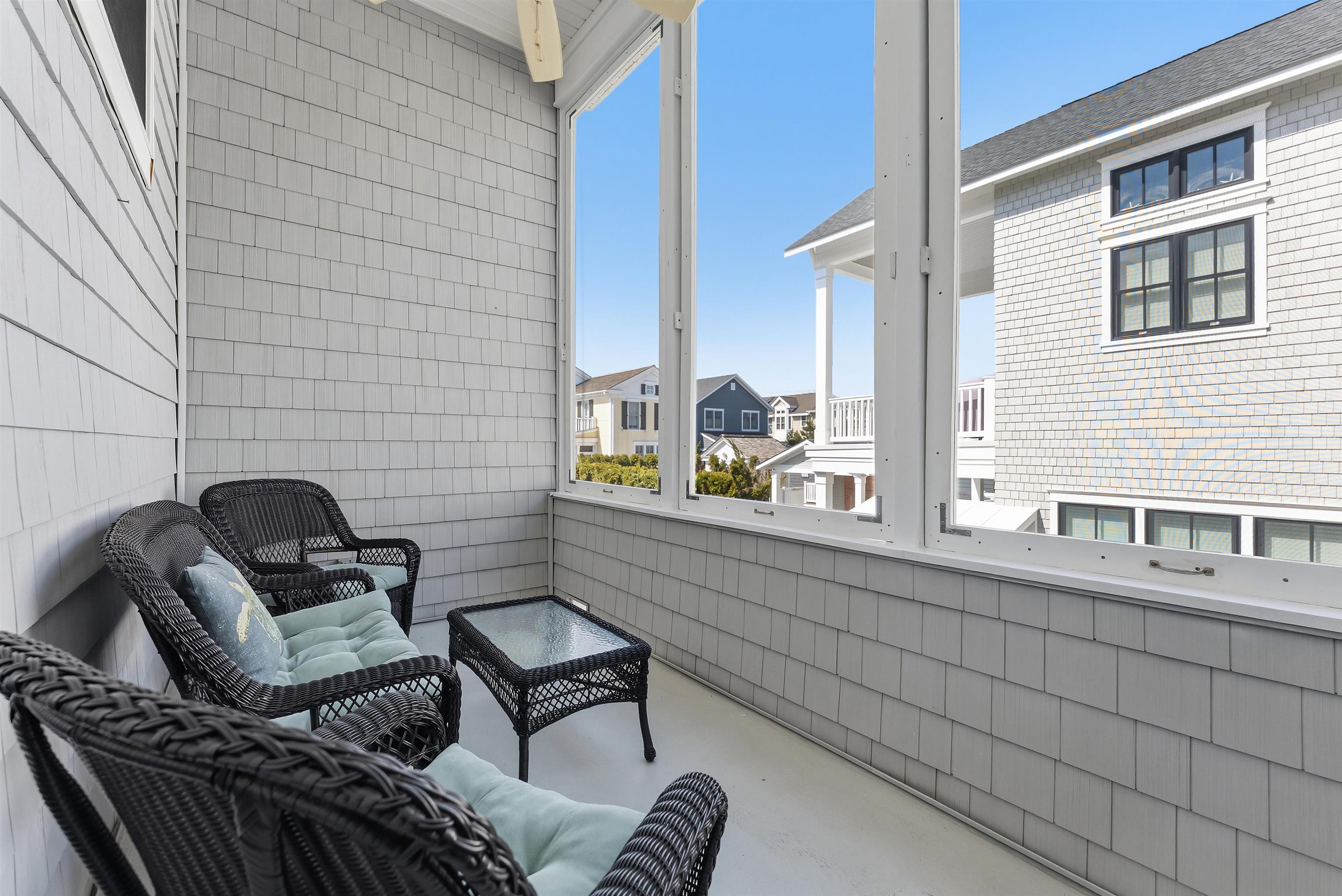 125 98th Street Stone Harbor, NJ 08247 - Photo 26 of 42 a couple of chairs that are sitting in a balcony