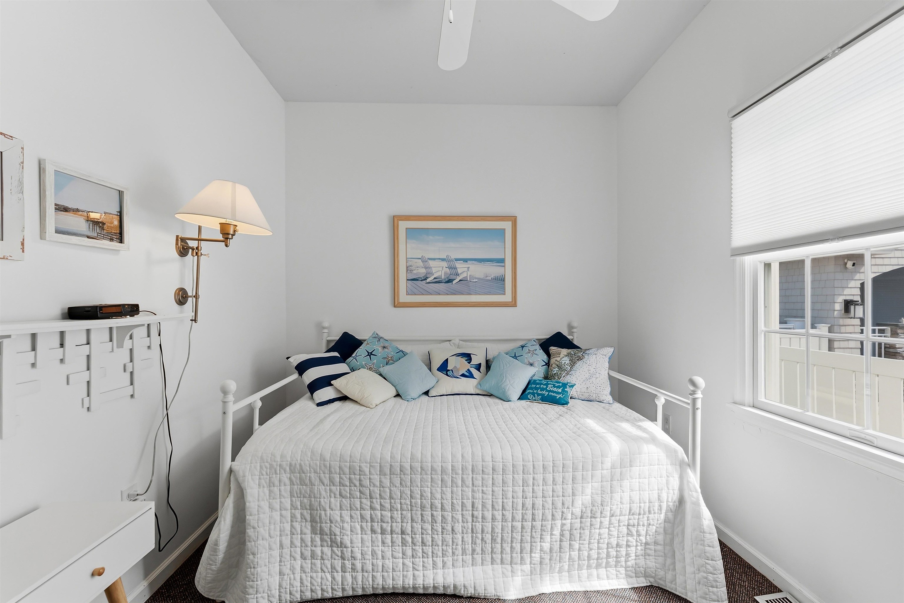 125 98th Street Stone Harbor, NJ 08247 - Photo 28 of 42 a bedroom with bed and paintings on the wall