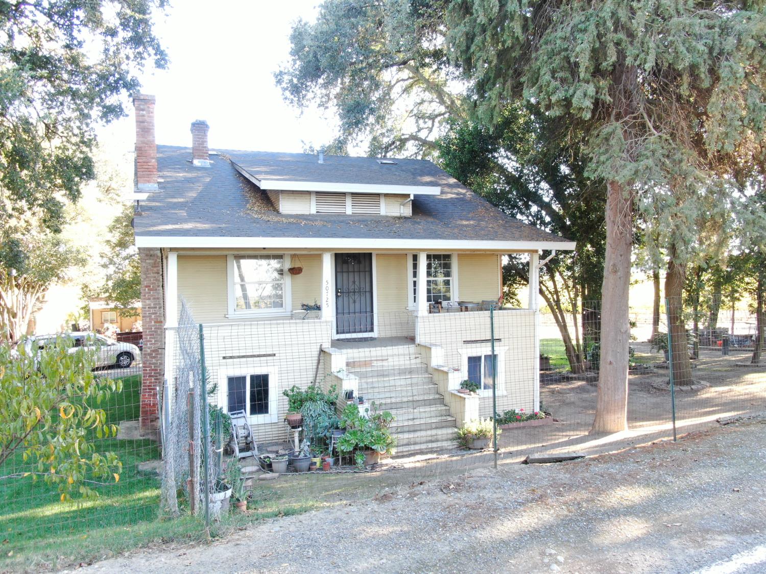 50725 Babel Slough Road Clarksburg, CA 95612 - Photo 14 of 19 a view of a brick house next to a yard with large trees
