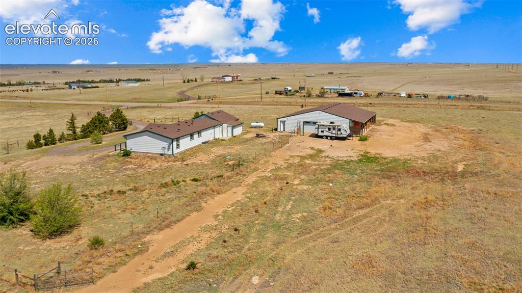 33975 Highway 94 Yoder, CO 80864 - Photo 31 of 40 Expansive property featuring a ranch-style residence and a large outbuilding with multiple garage doors
