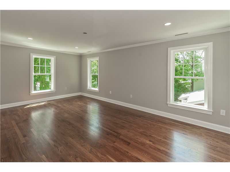 58 Middlesex Road Darien, CT 06820 - Photo 12 of 20 an empty room with wooden floor and windows