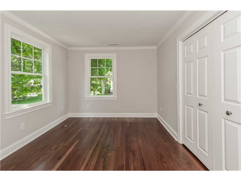 58 Middlesex Road Darien, CT 06820 - Photo 14 of 20 an empty room with wooden floor and windows