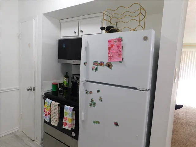 a white refrigerator freezer sitting inside of a kitchen