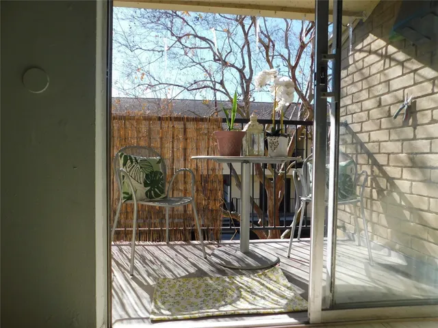 a view of a door of a house with wooden floor
