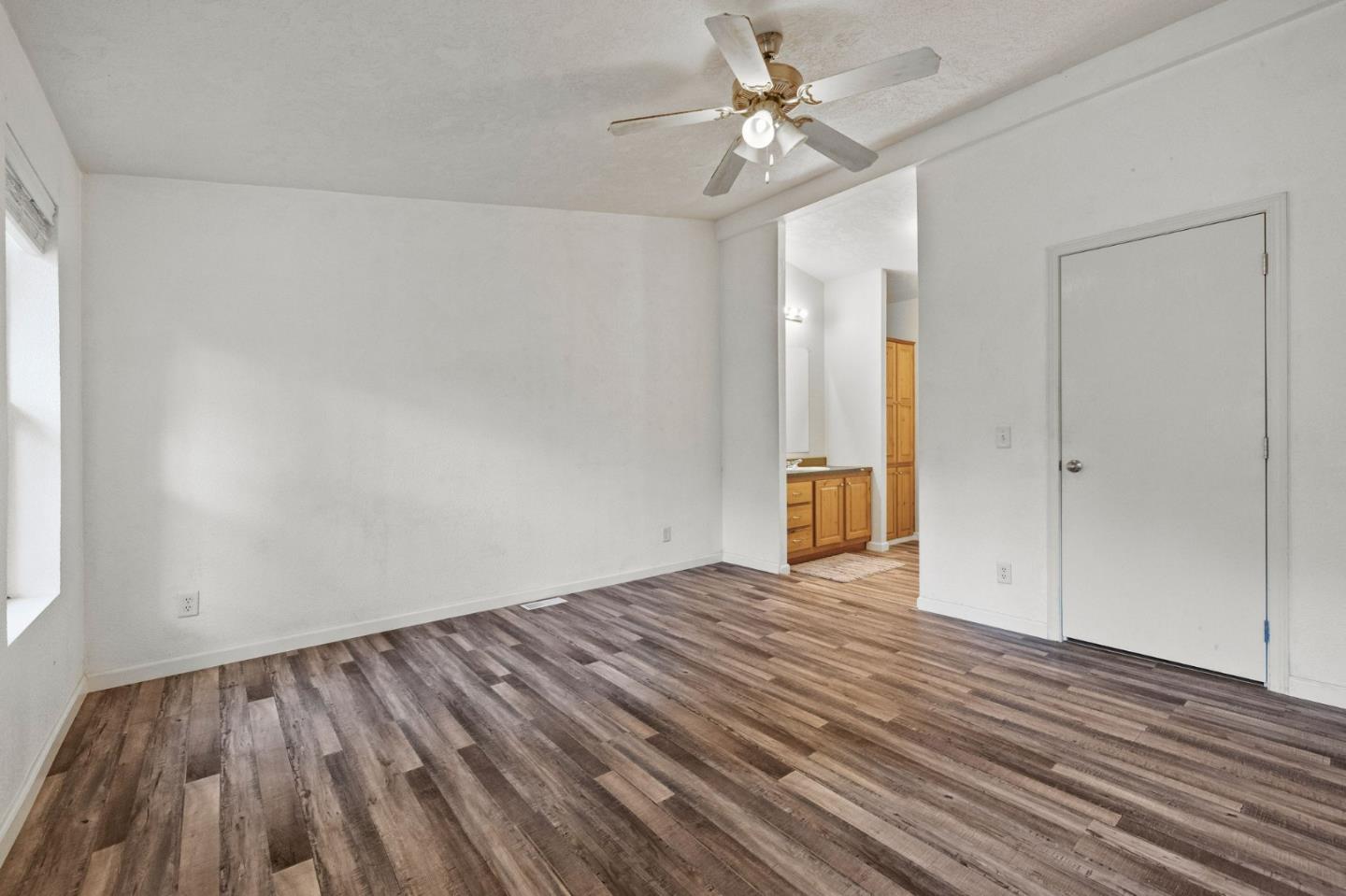 19307 Ferretti Road Groveland, CA 95321 - Photo 13 of 33 an empty room with wooden floor and ceiling fan